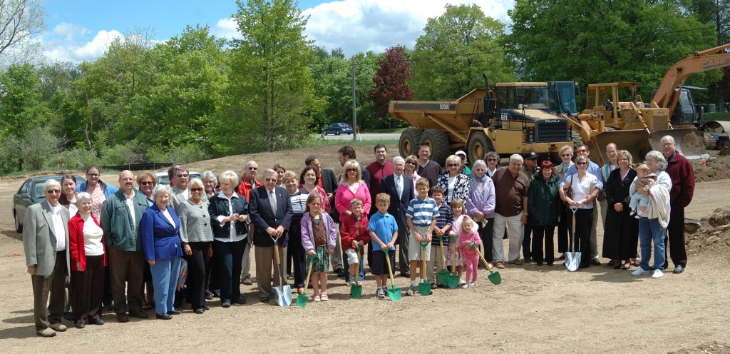 Member gather during the groundbreaking ceremoney for the church building